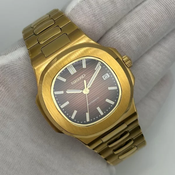 montre nautilus or jaune rouge